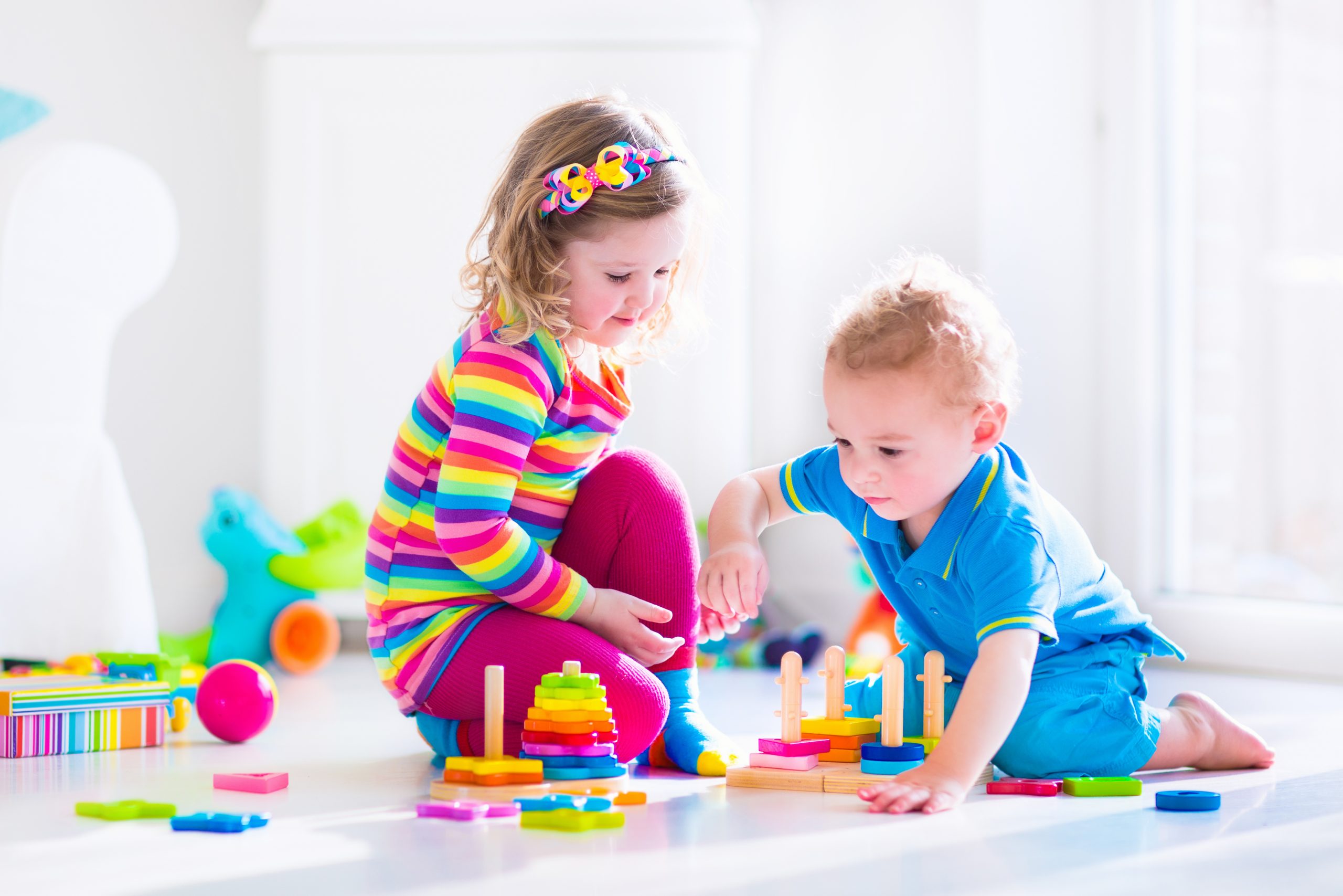 Cjildren playing with wooden toys